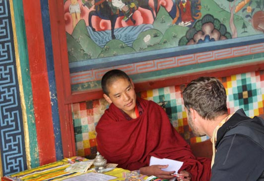A Northwest Rafting guest talks with a young Buddhist monk.