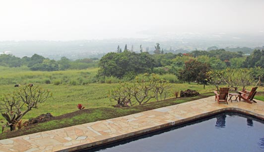 Holualoa Inn, a Big Island boutique hotel, provides a panoramic view across a coffee plantation to the ocean.