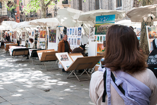 Artists, florists and performers line the edges of Las Ramblas on the way to La Boqueria Market.